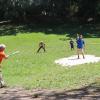 Curt Vander Vere swings at a pitch from Anthony V. Rode while playing baseball with Cuban youngsters near Ernest Hemingway's house in suburban Havana.