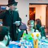 Participants help a roving gumshoe sift through clues during last year's Murder Mystery Dinner.