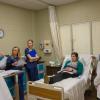 During an Interdisciplinary Professional Education event at Penn College, students from several majors discuss a patient case, including what treatment each professional would provide and what information each would gather and share with professionals from other departments. The patient, in bed, is played by physician assistant student Danielle M. Klock, of Sunbury. Facilitating the discussion is Wayne E. Reich (left), director of nursing, bachelor degrees.