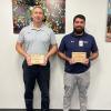 McAfee (left) and Coppadge display their awards for exceptional job performance.