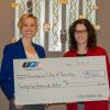 Elizabeth A. Biddle, left, director of corporate relations for Penn College, accepts a gift of $25,000 from Ann Blaskiewicz, community relations manager north for UGI Utilities. The gift supports the college Penn College NOW and SMART Girls programs, both of which promote technology education for high school students.