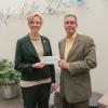 Brian Fuhrman, public sector solutions major account manager for Waste Management, presents a check to Elizabeth A. Biddle, director of corporate relations for Pennsylvania College of Technology. The $8,500 gift will support the college’s Penn College NOW dual-enrollment program and SMART Girls summer camp. Both are for high school students.